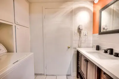 a white bathroom with a shower and a sink at Free Parking! Montreal Comfort Value Convenience! Full Kitchen, Fast Wifi, Workspace, Smart TV! in Montréal