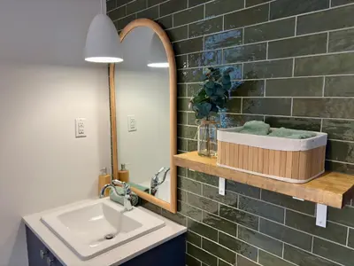 a bathroom with a sink and a mirror at Pur Nature Garthby et Sauna in Saint-Gérard
