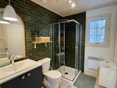 a bathroom with a shower and a toilet and a sink at Pur Nature Garthby et Sauna in Saint-Gérard