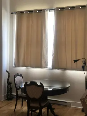 a room with a table and chairs and a window at Le Loft des Milles-Îles in Laval