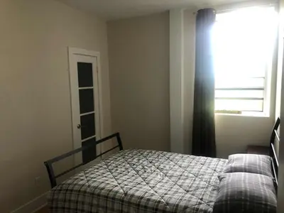 a bedroom with a bed and a window at Le Loft des Milles-Îles in Laval