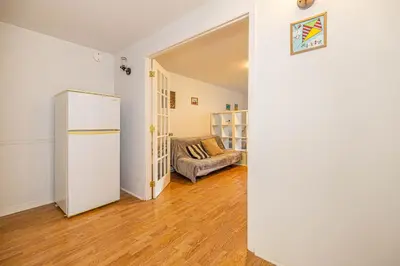 a living room with a refrigerator and a couch at Cozy 1 BDR apt in MTL-E, near metro, free parking in Montréal