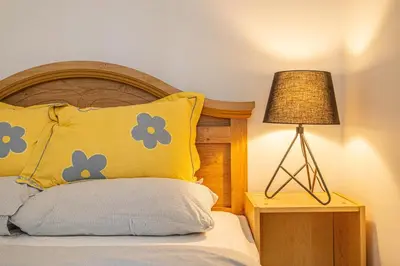 a bed with a yellow pillow and a lamp at Cozy 1 BDR apt in MTL-E, near metro, free parking in Montréal