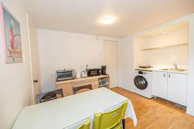 a kitchen with a table and a washing machine at Cozy 1 BDR apt in MTL-E, near metro, free parking in Montréal