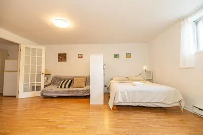 a bedroom with two beds and a couch at Cozy 1 BDR apt in MTL-E, near metro, free parking in Montréal