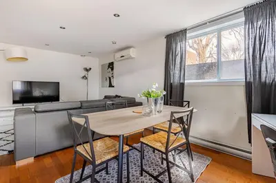 a living room with a table and a couch at Voltaire 1 Apartement 4,5 2ch Laval, Canada in Laval