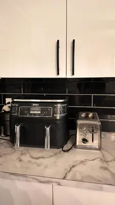 a kitchen with a stove and a counter top at Entire Urban Cabin Retreat 3BD Terrace&Covered Parking in Terrebonne