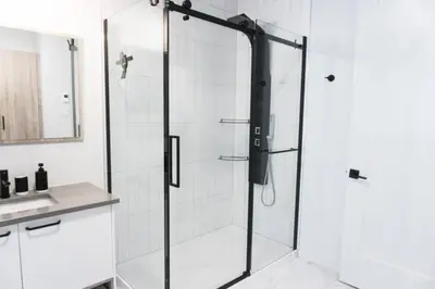 a shower with a glass door in a bathroom at Lynx spa detente Orford in Magog-Orford
