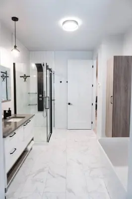 a white bathroom with a tub and a sink at Lynx spa detente Orford in Magog-Orford