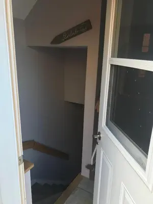 a door to a room with a stairwell in a room at Charmant petit studio à 15 minutes de Montréal in Longueuil