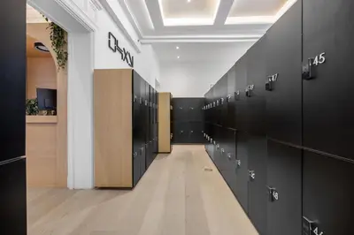 a row of black lockers in a locker room at Capsule Residence in Montréal