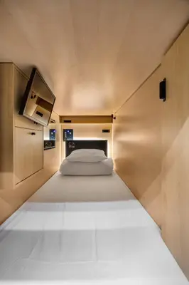 a small bedroom with a bed in a room at Capsule Residence in Montréal