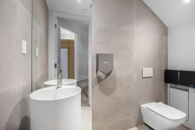 a bathroom with a white toilet and a sink at Capsule Residence in Montréal