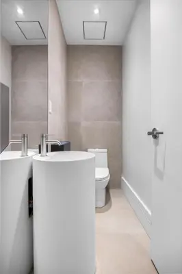 a bathroom with two sinks and a toilet at Capsule Residence in Montréal