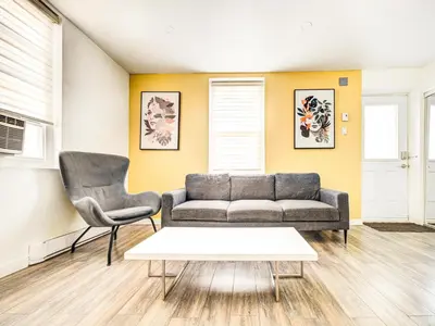 a living room with a couch and two chairs at Griffintown Cozy Haven in Montréal