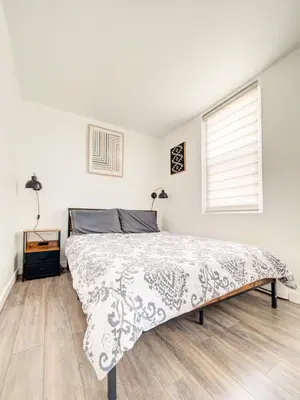 a bedroom with a bed and a window at Griffintown Cozy Haven in Montréal