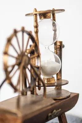 an hourglass sitting on top of a wooden table at Griffintown Cozy Haven in Montréal