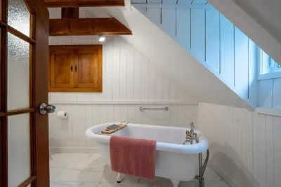a bathroom with a bath tub in a attic at Lakefront - Quai 948 in Saint Sebastien