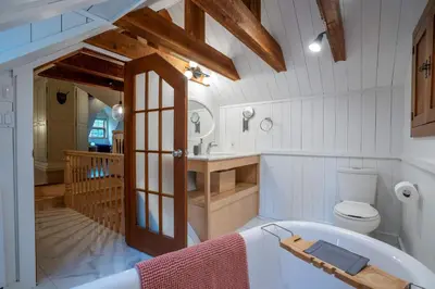 a bathroom with a tub and a toilet and a sink at Lakefront - Quai 948 in Saint Sebastien