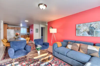 a living room with a blue couch and a red wall at Beautiful Spacious Apartments! 6 guest Vacation home Montreal in Montréal