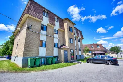 a building with a car parked in front of it at Beautiful Spacious Apartments! 6 guest Vacation home Montreal in Montréal