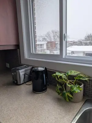 a kitchen counter with a sink and a window at Chambre privée 5 min Université Hôpital in Trois-Rivières