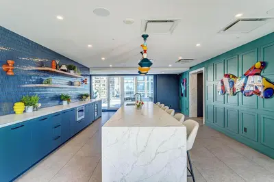 a kitchen with blue cabinets and a large marble table at Montreal - Stanbrooke Galaxie - 1BR 1302 in Montréal