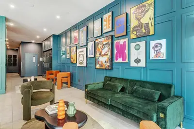 a living room with a green couch and a blue wall at Montreal - Stanbrooke Galaxie - 1BR 1302 in Montréal