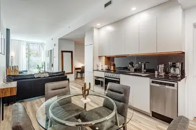 a kitchen and living room with a glass table at Montreal - Stanbrooke Galaxie - 1BR 1302 in Montréal