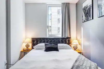 a bedroom with a large bed with two lamps at Montreal - Stanbrooke Galaxie - 1BR 1302 in Montréal