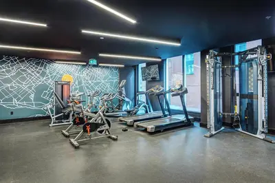 a gym with several tread machines and a mural at Montreal - Stanbrooke Galaxie - 1BR 1302 in Montréal