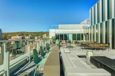 a balcony with chairs and tables on a building at Montreal - Stanbrooke Galaxie - 1BR 1302 in Montréal
