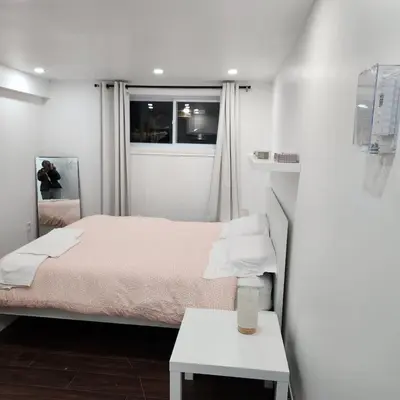 a small bedroom with a bed and a window at Cute and Cozy Studio with Private Parking in Montréal