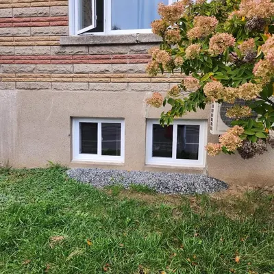 a building with three windows on the side of it at Cute and Cozy Studio with Private Parking in Montréal