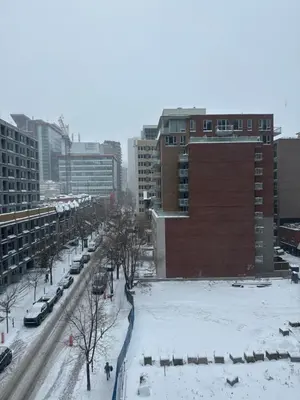 a city street covered in snow with buildings at Dreamzsuite in Montréal