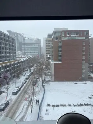a view of a snowy city street with buildings at Dreamzsuite in Montréal