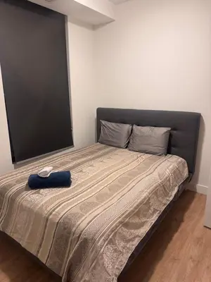 a bed with a black headboard in a bedroom at Dreamzsuite in Montréal