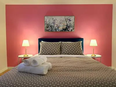 a bedroom with a large bed with two lamps at Free Parking! Fast Wifi! Comfortable Apt for Montreal Explorers & Adventure! in Montréal