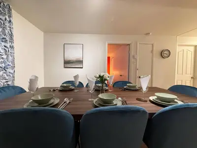 a dining room table with blue chairs and a wooden table at Free Parking! Fast Wifi! Comfortable Apt for Montreal Explorers & Adventure! in Montréal