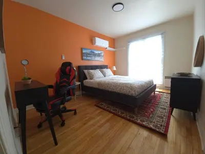 a bedroom with a bed and a desk and a chair at Special Stays! Ultimate Destination for Montreal & West Island with Fast Wi-Fi in Montréal