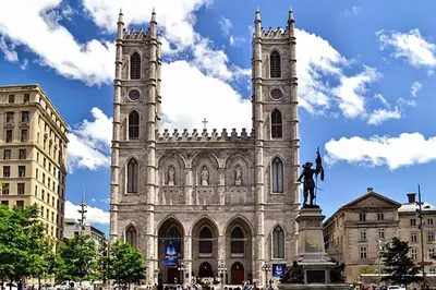 a church with a statue in front of it at Special Stays! Ultimate Destination for Montreal & West Island with Fast Wi-Fi in Montréal