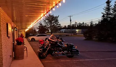 a motorcycle parked on the side of a street at Motel Alexandrin in Saint-Georges