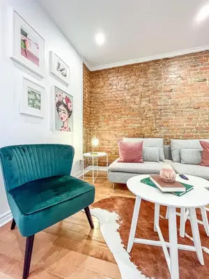 a living room with a couch and a table at Upscale 2BR Retreat - Parking - 2 Queen Suites in Montréal