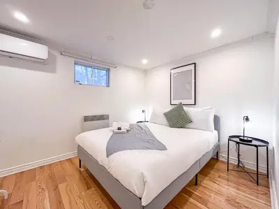 a bedroom with a large white bed in a room at Luxury 3BR - Free Parking - Washer & Dryer in Montréal