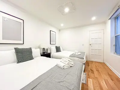 a white room with two beds and a couch at Luxury 3BR - Free Parking - Washer & Dryer in Montréal