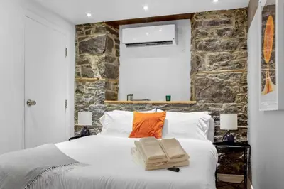 a bedroom with a bed with two towels on it at Elegant 1BR Suite - Washer & Dryer - Prime Location in Montréal