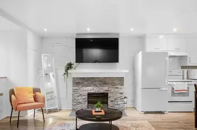 a living room with a fireplace and a tv at Elegant 1BR Suite - Washer & Dryer - Prime Location in Montréal
