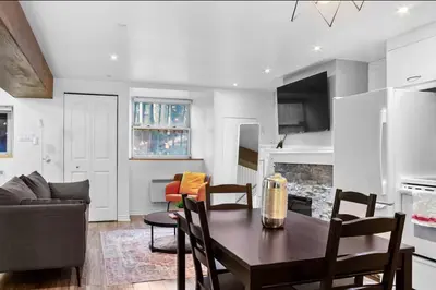 a kitchen and living room with a table and a couch at Elegant 1BR Suite - Washer & Dryer - Prime Location in Montréal