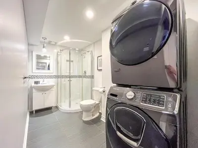 a bathroom with a toilet and a microwave at Elegant 1BR Suite - Washer & Dryer - Prime Location in Montréal