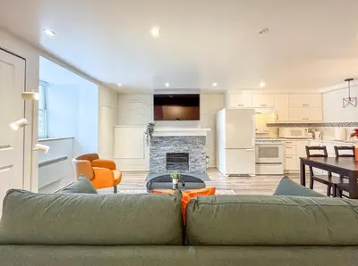 a living room with a couch and a kitchen at Elegant 1BR Suite - Washer & Dryer - Prime Location in Montréal